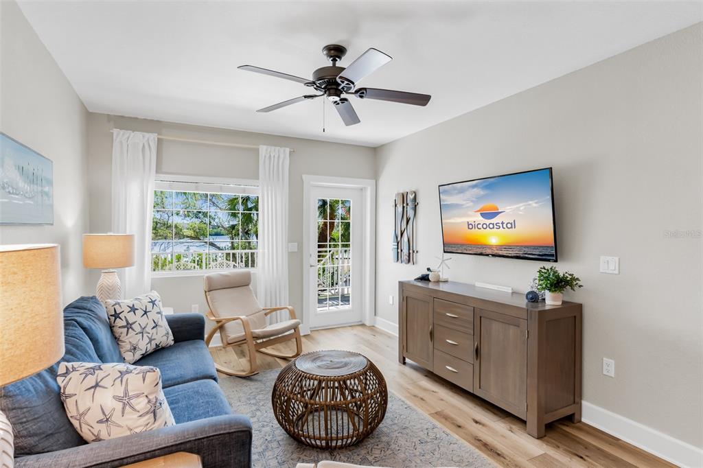 399 2nd Street, Unit 215 Indian Rocks Beach, FL 33785 - Photo 5 of 51 a living room with furniture and a flat screen tv