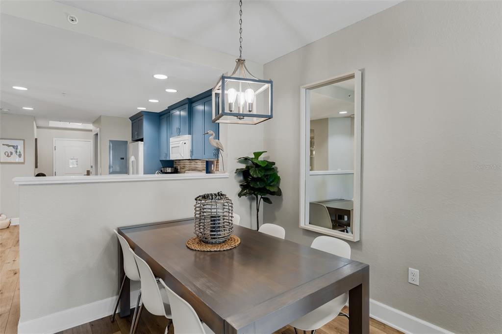399 2nd Street, Unit 215 Indian Rocks Beach, FL 33785 - Photo 8 of 51 a kitchen with a table and chairs