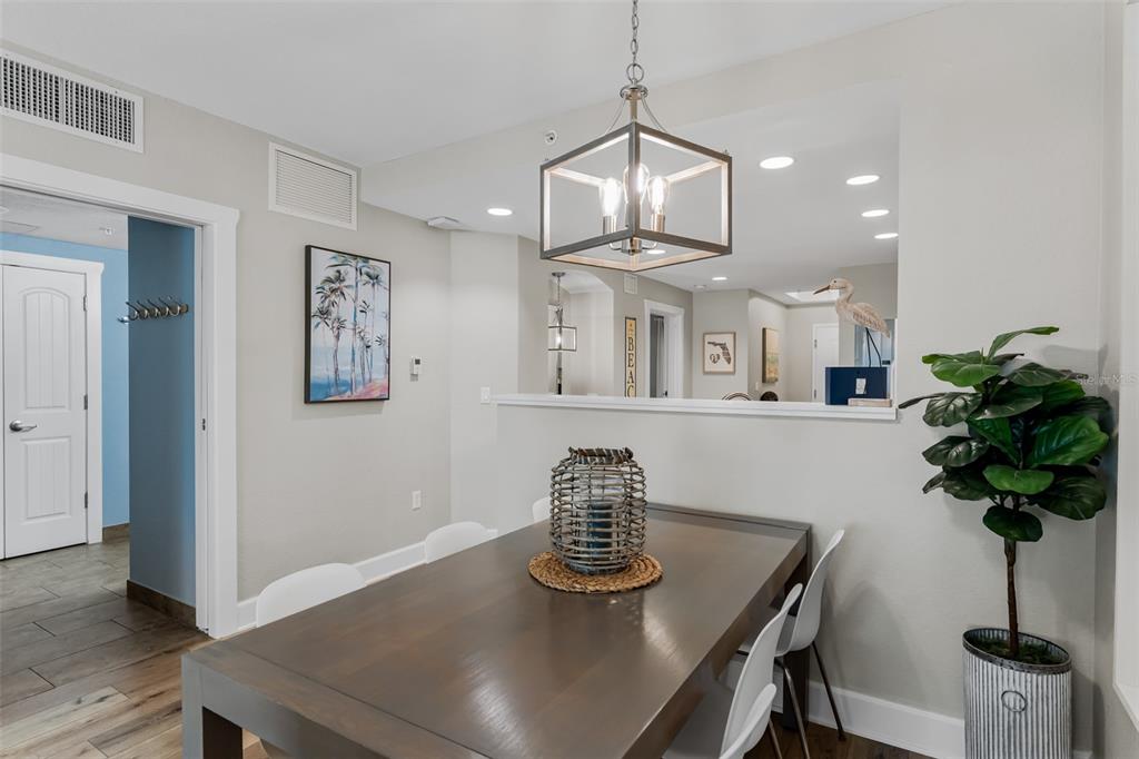 399 2nd Street, Unit 215 Indian Rocks Beach, FL 33785 - Photo 9 of 51 a view of a dining room with furniture and chandelier