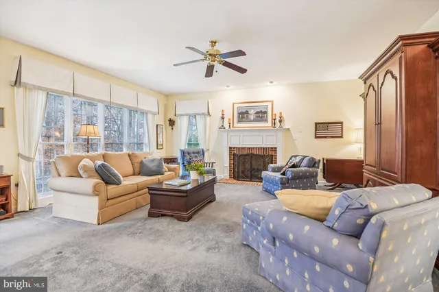 a living room with furniture and a painting on the wall