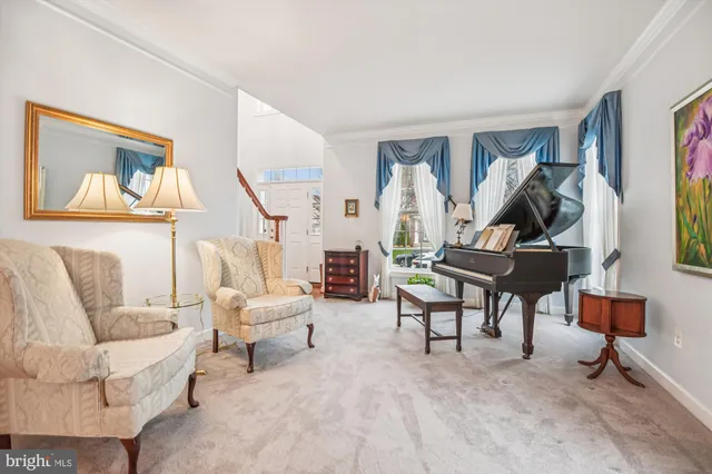a living room with furniture a rug and a wall painting