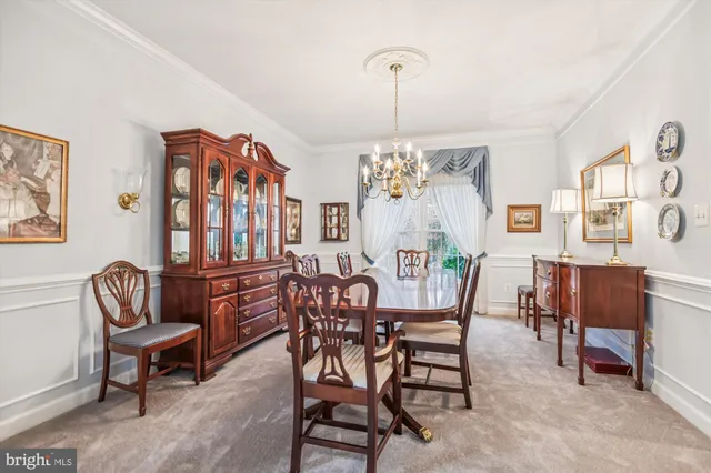 a view of a dining room with furniture and chandelier