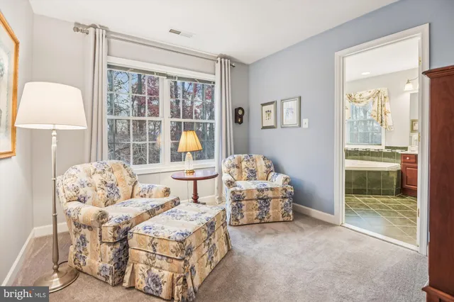 a spacious bathroom with a granite countertop sink and a large mirror