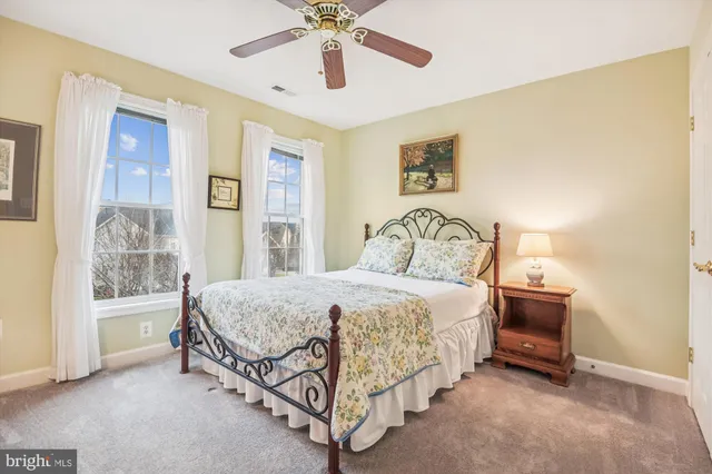 a bathroom with a sink a toilet and shower curtain