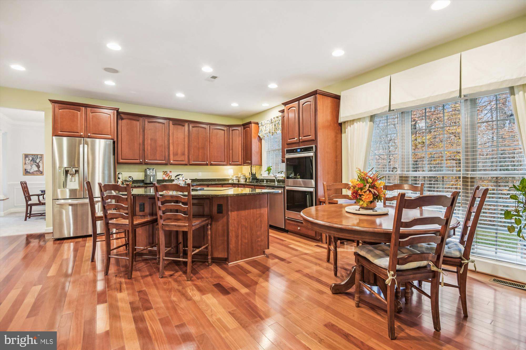 1584 Star Stella Drive Odenton, MD 21113 - Photo 6 of 45 a kitchen with stainless steel appliances kitchen island granite countertop wooden floors and white cabinets
