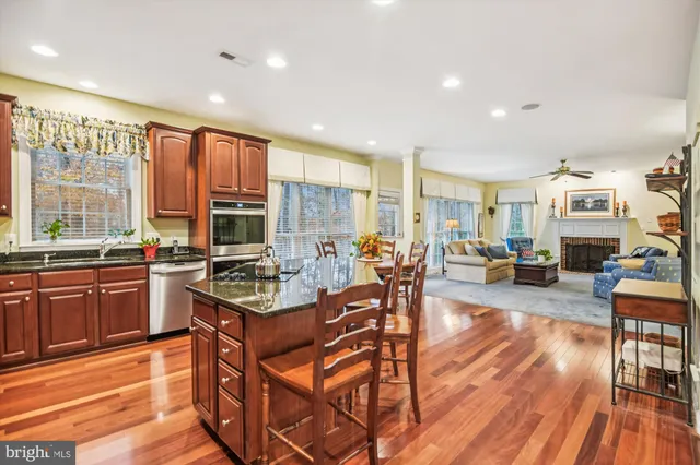 a kitchen with stainless steel appliances granite countertop sink refrigerator and microwave