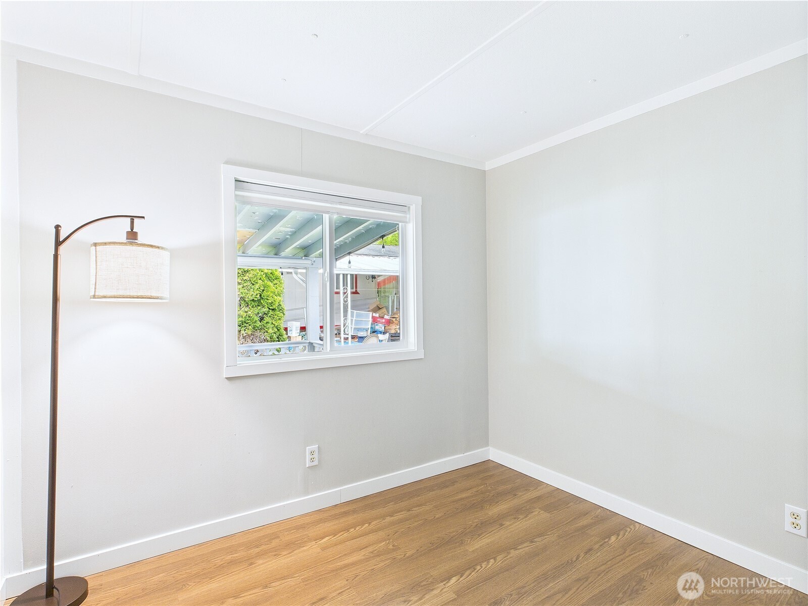 212 Old Owen Road, Unit 43 Sultan, WA 98294 - Photo 11 of 22 a view of an empty room with wooden floor and a window