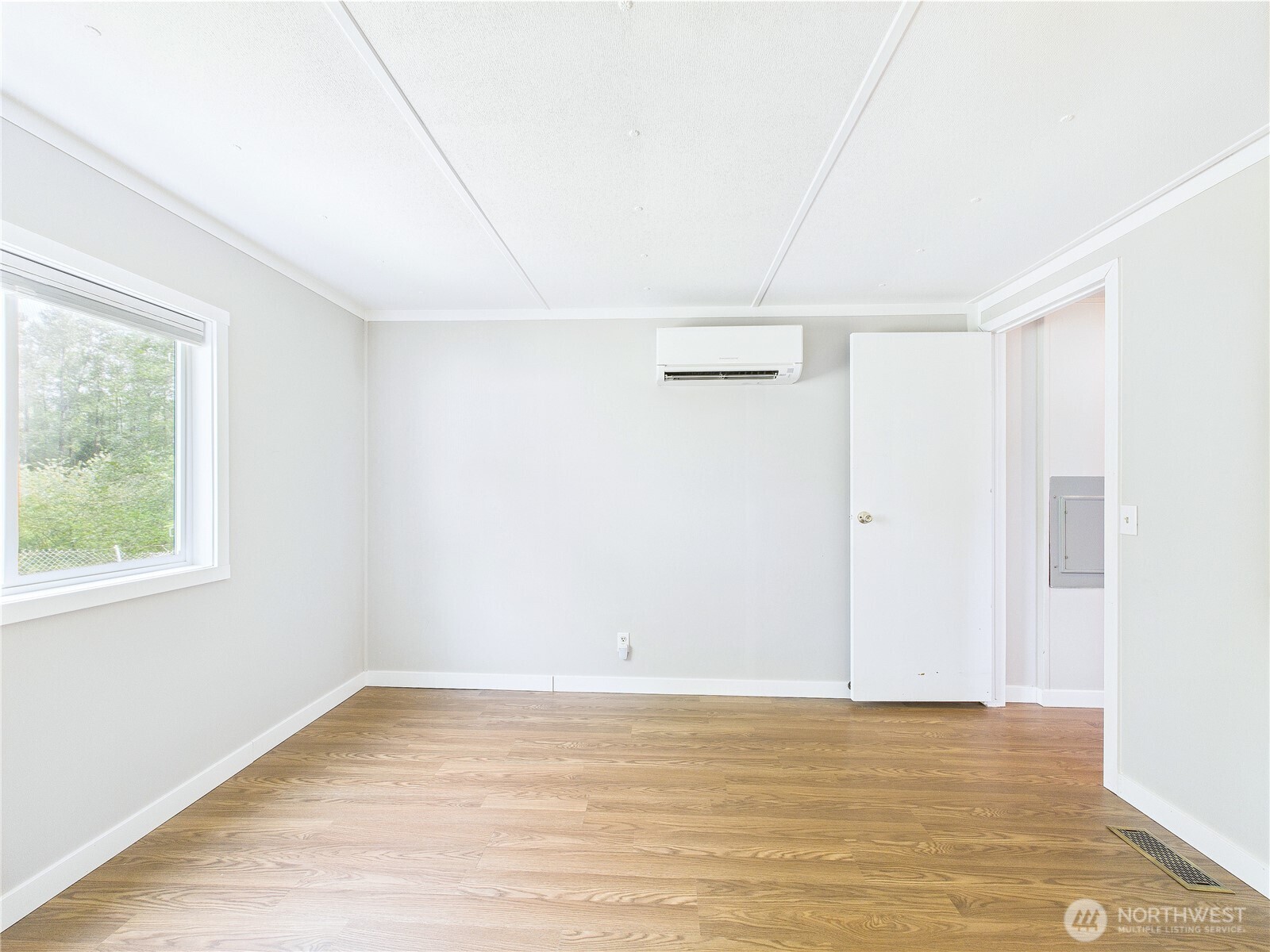212 Old Owen Road, Unit 43 Sultan, WA 98294 - Photo 16 of 22 a view of an empty room with wooden floor and a window