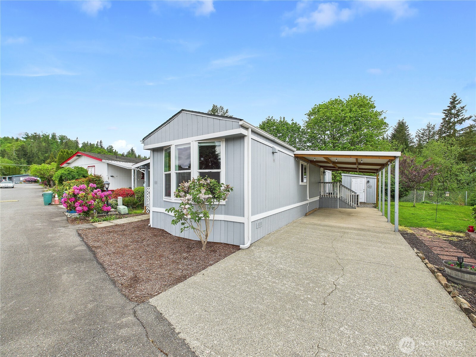 212 Old Owen Road, Unit 43 Sultan, WA 98294 - Photo 3 of 22 a front view of a house with a yard and garage