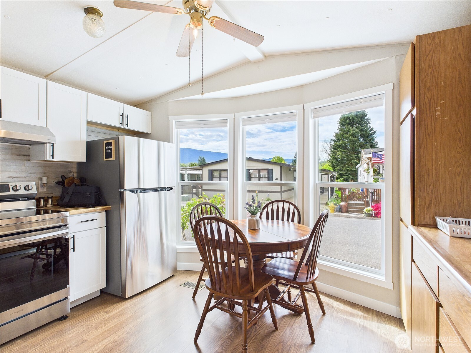 212 Old Owen Road, Unit 43 Sultan, WA 98294 - Photo 7 of 22 a dining room with furniture a chandelier and wooden floor