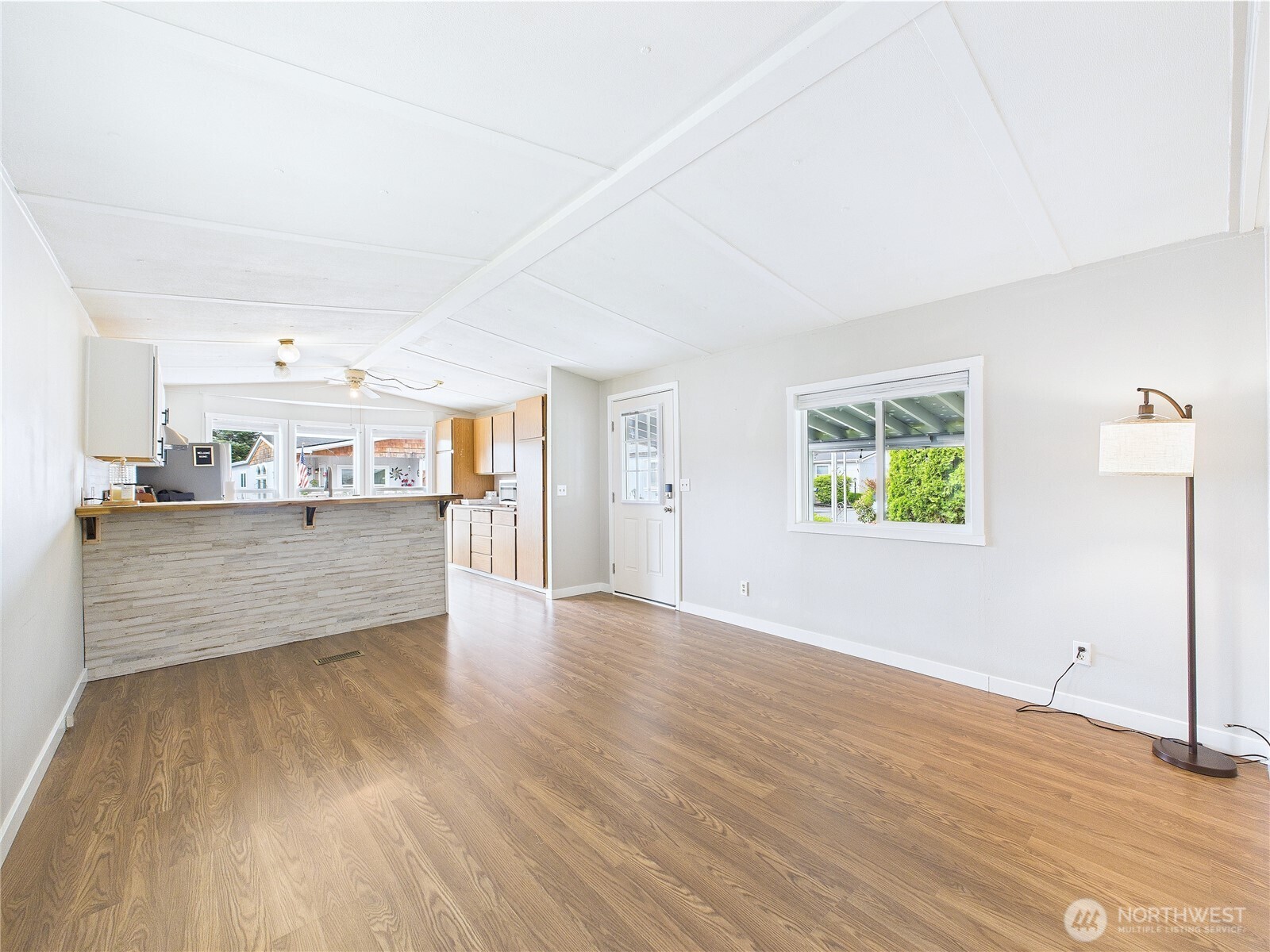 212 Old Owen Road, Unit 43 Sultan, WA 98294 - Photo 10 of 22 a view of a kitchen with wooden floor and windows