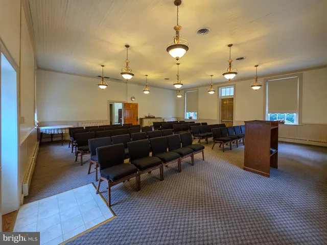 a room with lots of chairs and a table