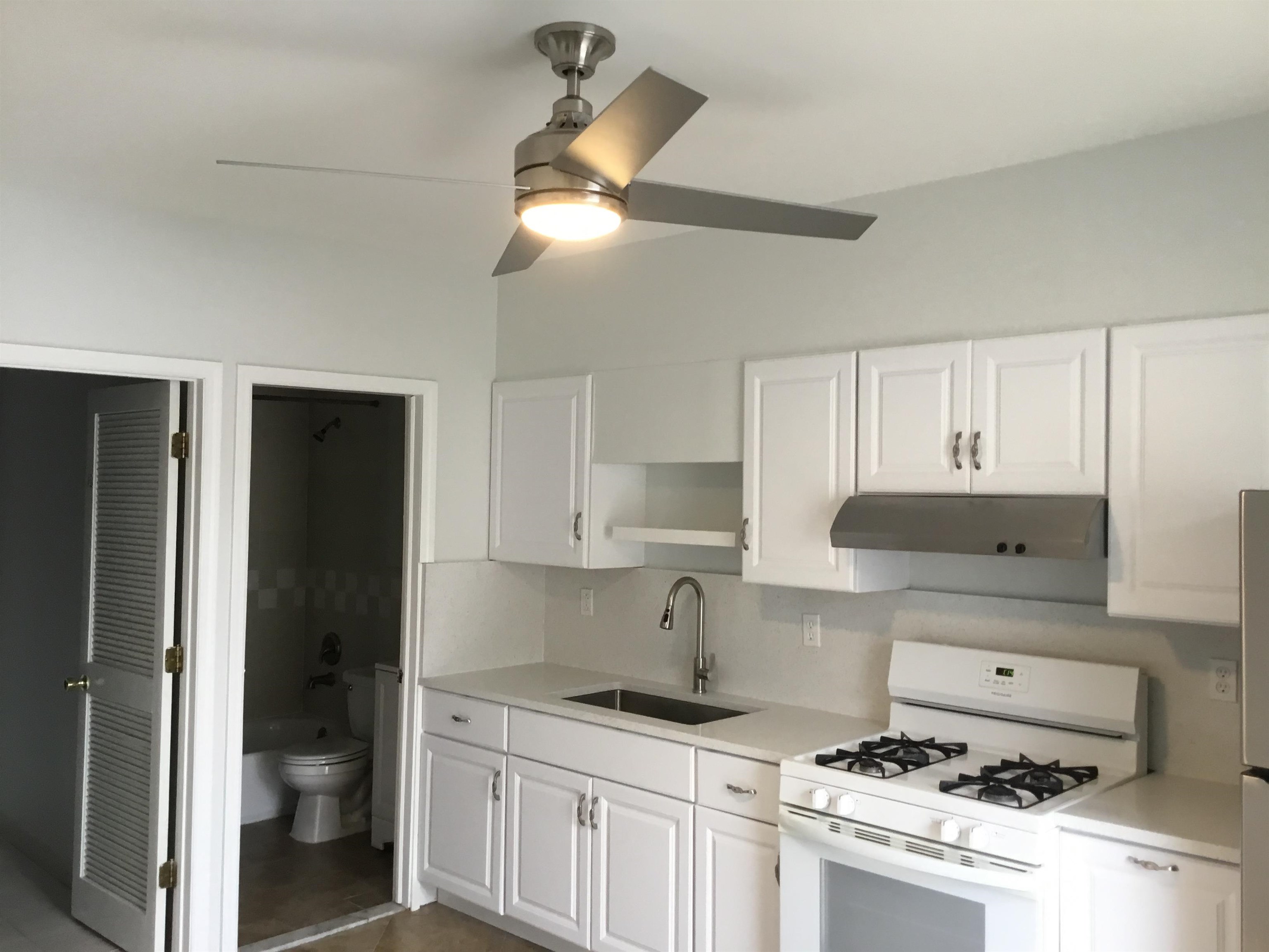 90 Union Avenue, Unit 2 Little Ferry, NJ 07643 - Photo 3 of 25 a kitchen with stainless steel appliances a stove a refrigerator and cabinets