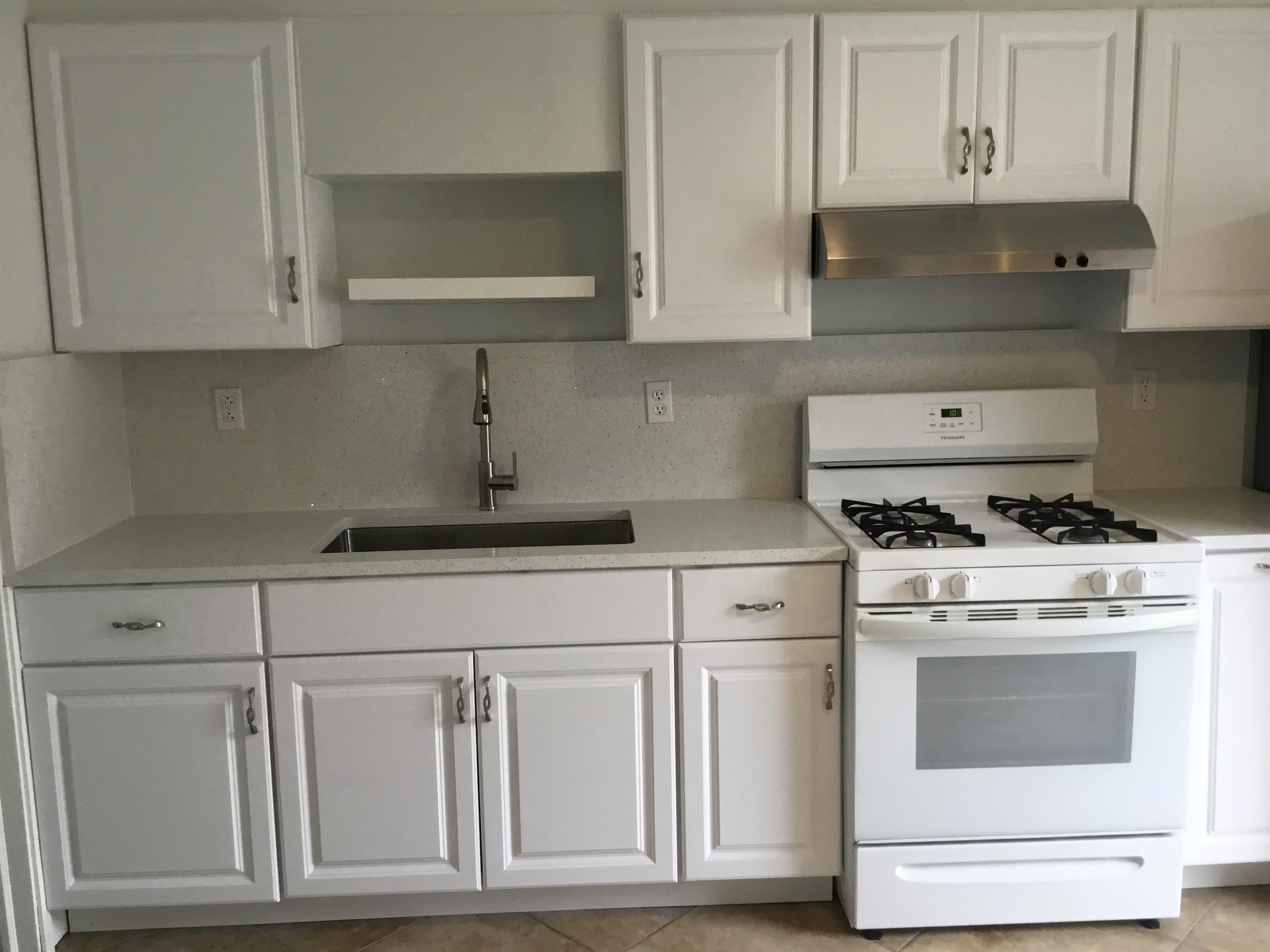 90 Union Avenue, Unit 2 Little Ferry, NJ 07643 - Photo 6 of 25 a kitchen with white cabinets and white appliances
