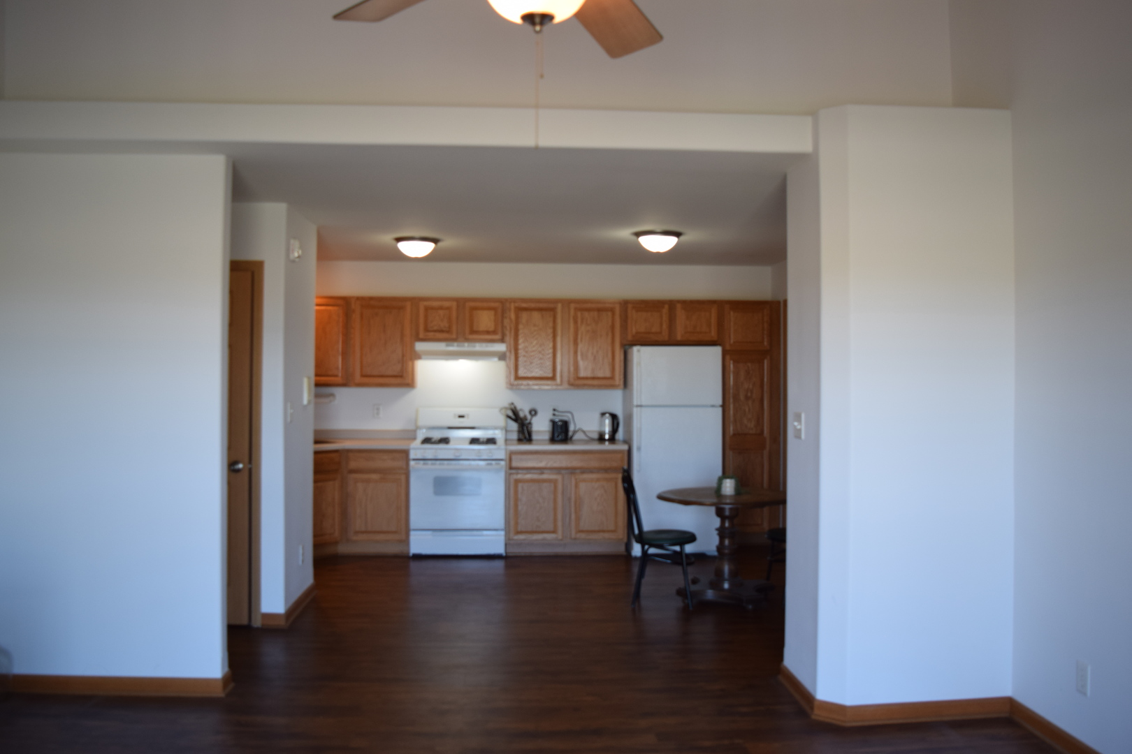 565 North Strack Street, Unit 302 Cortland, IL 60112 - Photo 4 of 15 a kitchen with stove and wooden floor