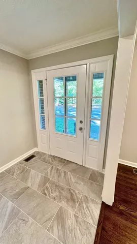 a view of an empty room and wooden floor