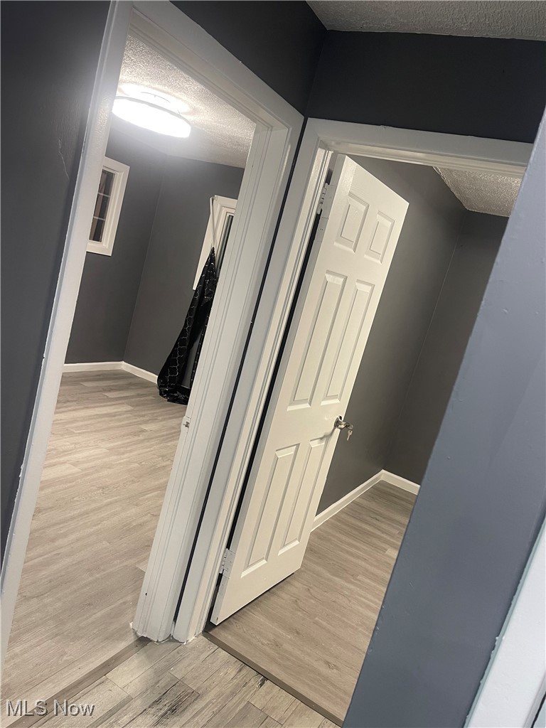 603 Liberty Road Youngstown, OH 44505 - Photo 20 of 42 Hall with a textured ceiling and light wood-style floors