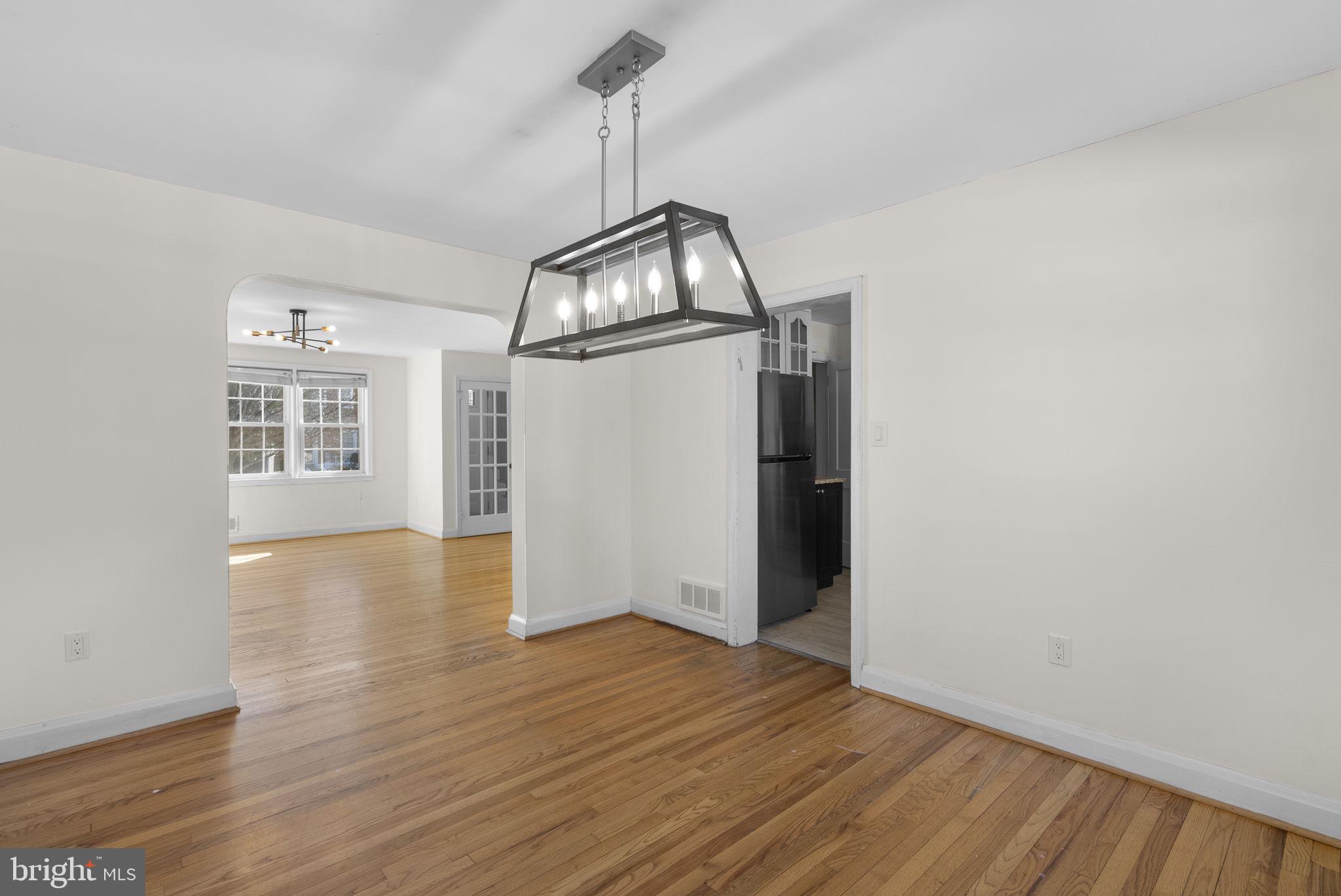 8204 Pleasant Plains Road Towson, MD 21286 - Photo 11 of 40 a view of a room with wooden floor ceiling fan and windows