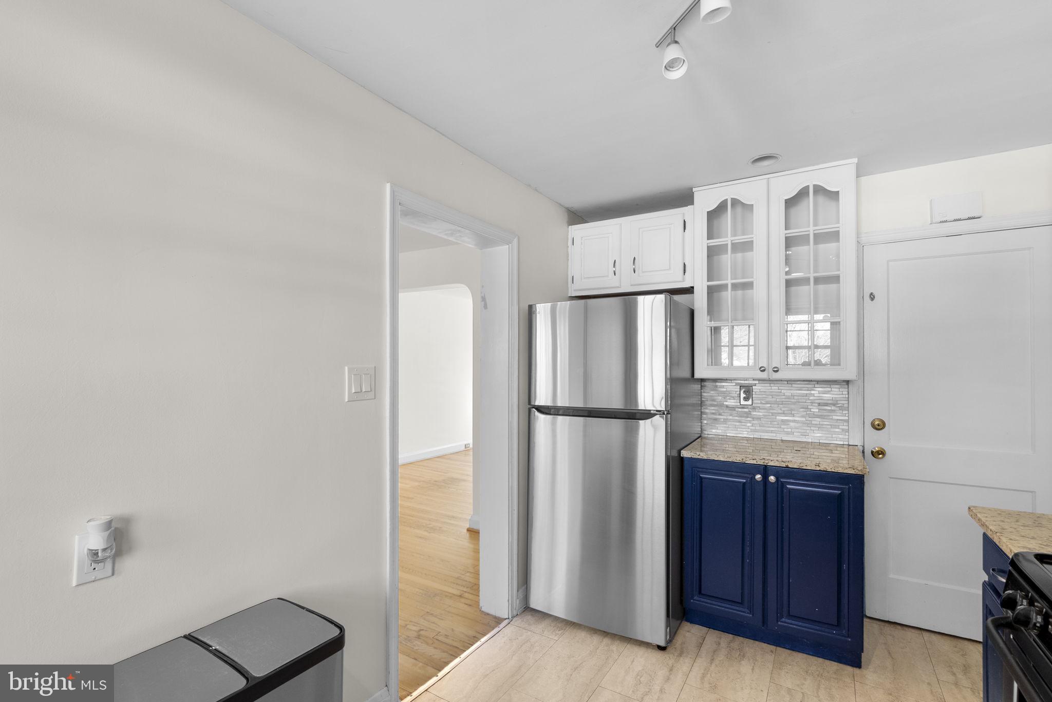 8204 Pleasant Plains Road Towson, MD 21286 - Photo 15 of 40 a view of kitchen with refrigerator cabinets and wooden floor