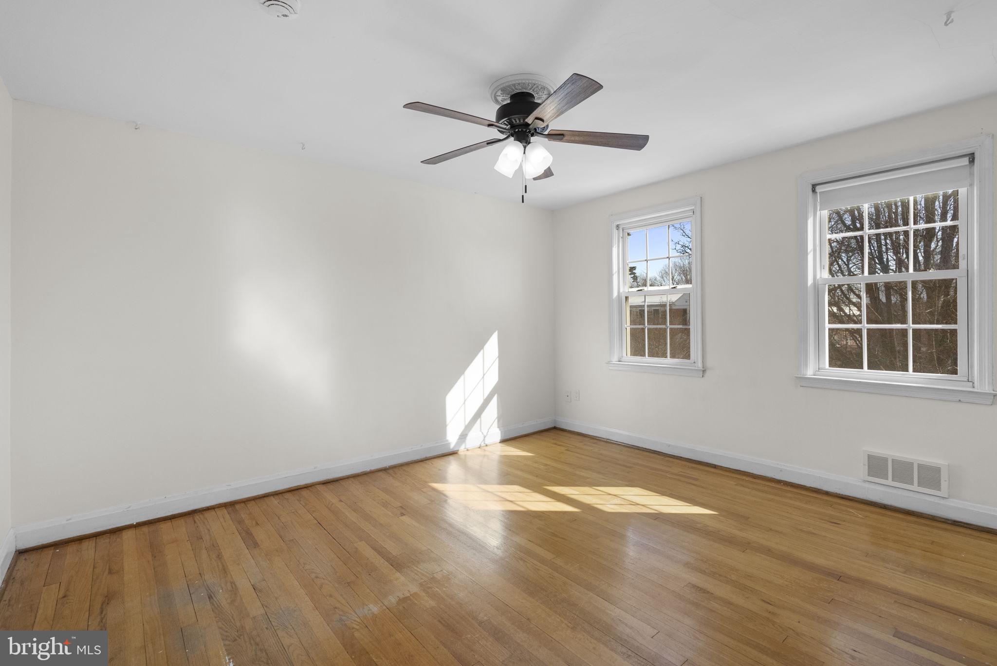 8204 Pleasant Plains Road Towson, MD 21286 - Photo 16 of 40 a view of an empty room with a window and wooden floor