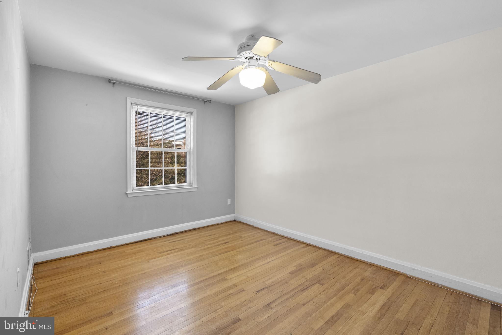 8204 Pleasant Plains Road Towson, MD 21286 - Photo 18 of 40 an empty room with wooden floor fan and windows