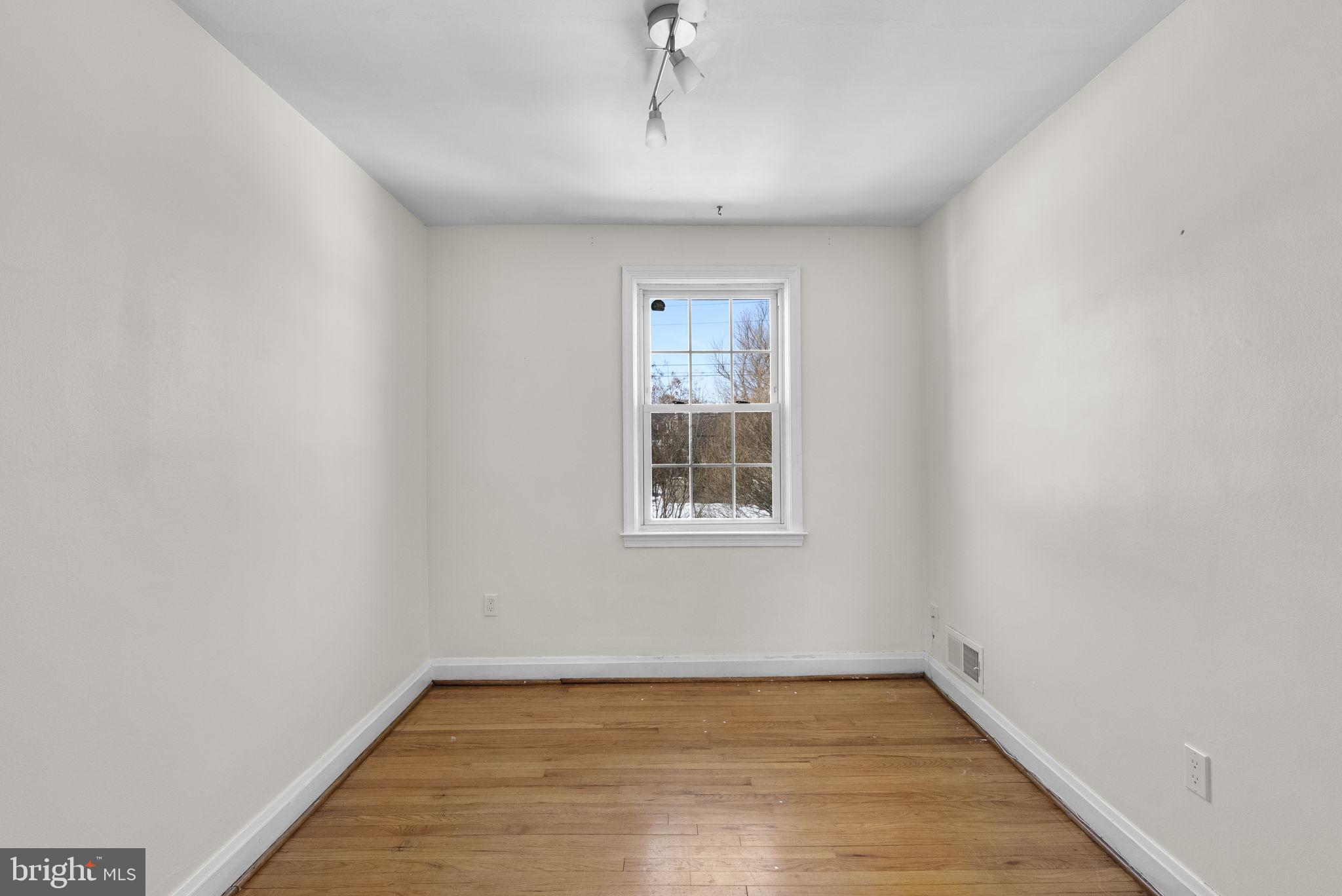 8204 Pleasant Plains Road Towson, MD 21286 - Photo 20 of 40 a view of an empty room with wooden floor and a window