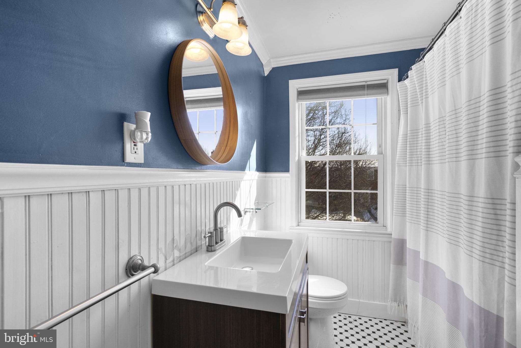 8204 Pleasant Plains Road Towson, MD 21286 - Photo 22 of 40 a bathroom with a sink a toilet and a window