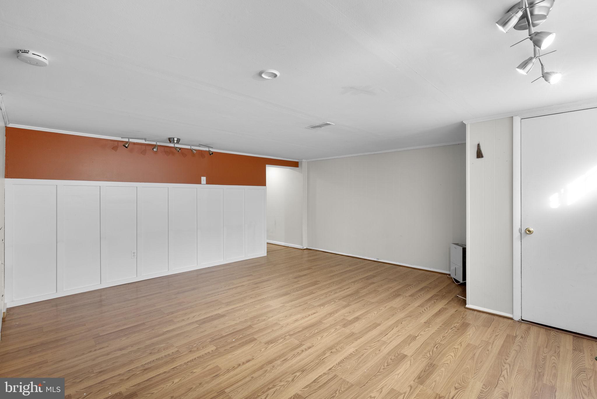 8204 Pleasant Plains Road Towson, MD 21286 - Photo 23 of 40 a view of an empty room with wooden floor and a window