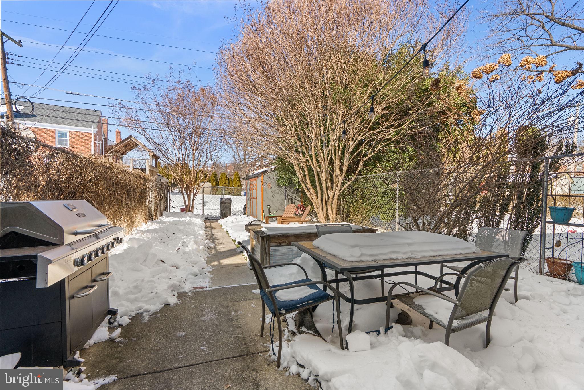 8204 Pleasant Plains Road Towson, MD 21286 - Photo 27 of 40 a view of a patio with table and chairs with wooden fence and plants