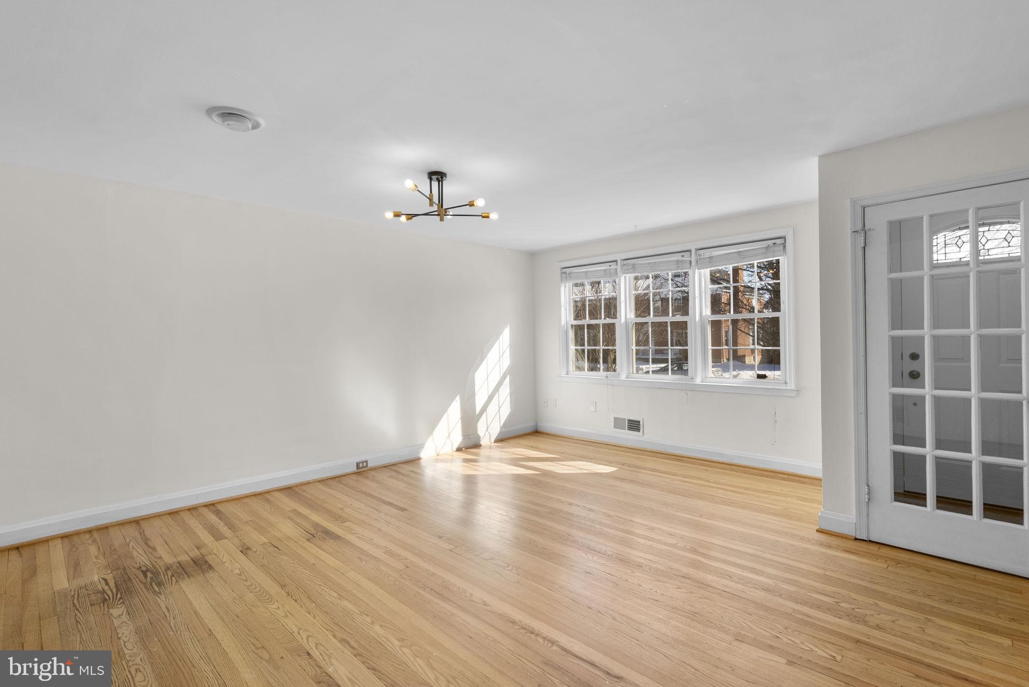 8204 Pleasant Plains Road Towson, MD 21286 - Photo 6 of 40 a view of empty room with wooden floor and fan
