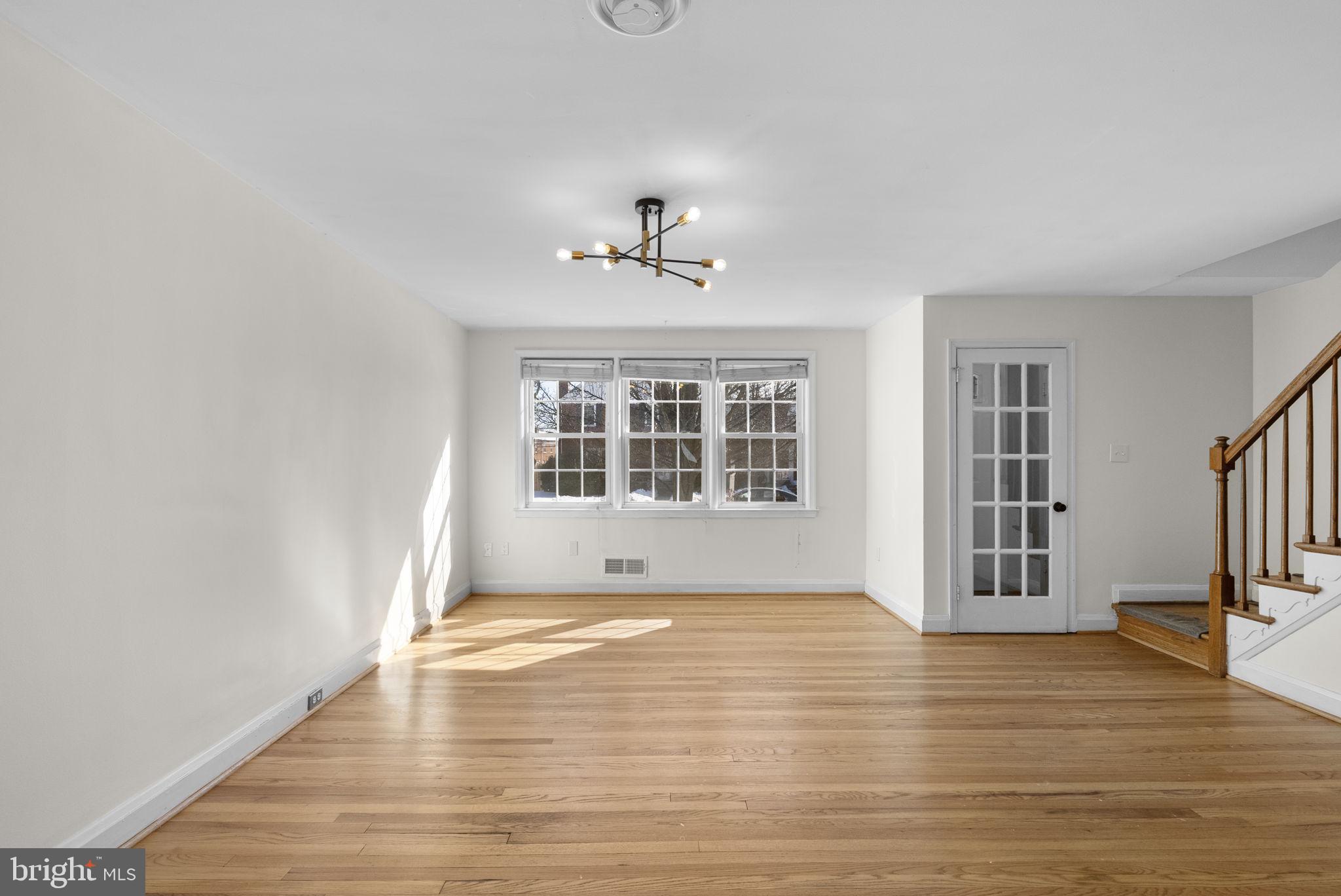 8204 Pleasant Plains Road Towson, MD 21286 - Photo 7 of 40 a view of an empty room with a window and wooden floor