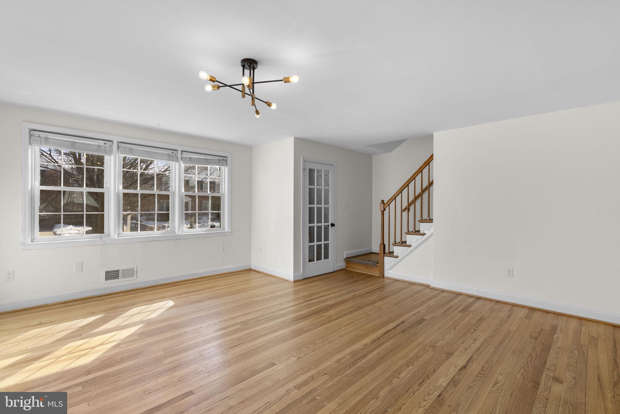 8204 Pleasant Plains Road Towson, MD 21286 - Photo 8 of 40 a view of an empty room with wooden floor and a window