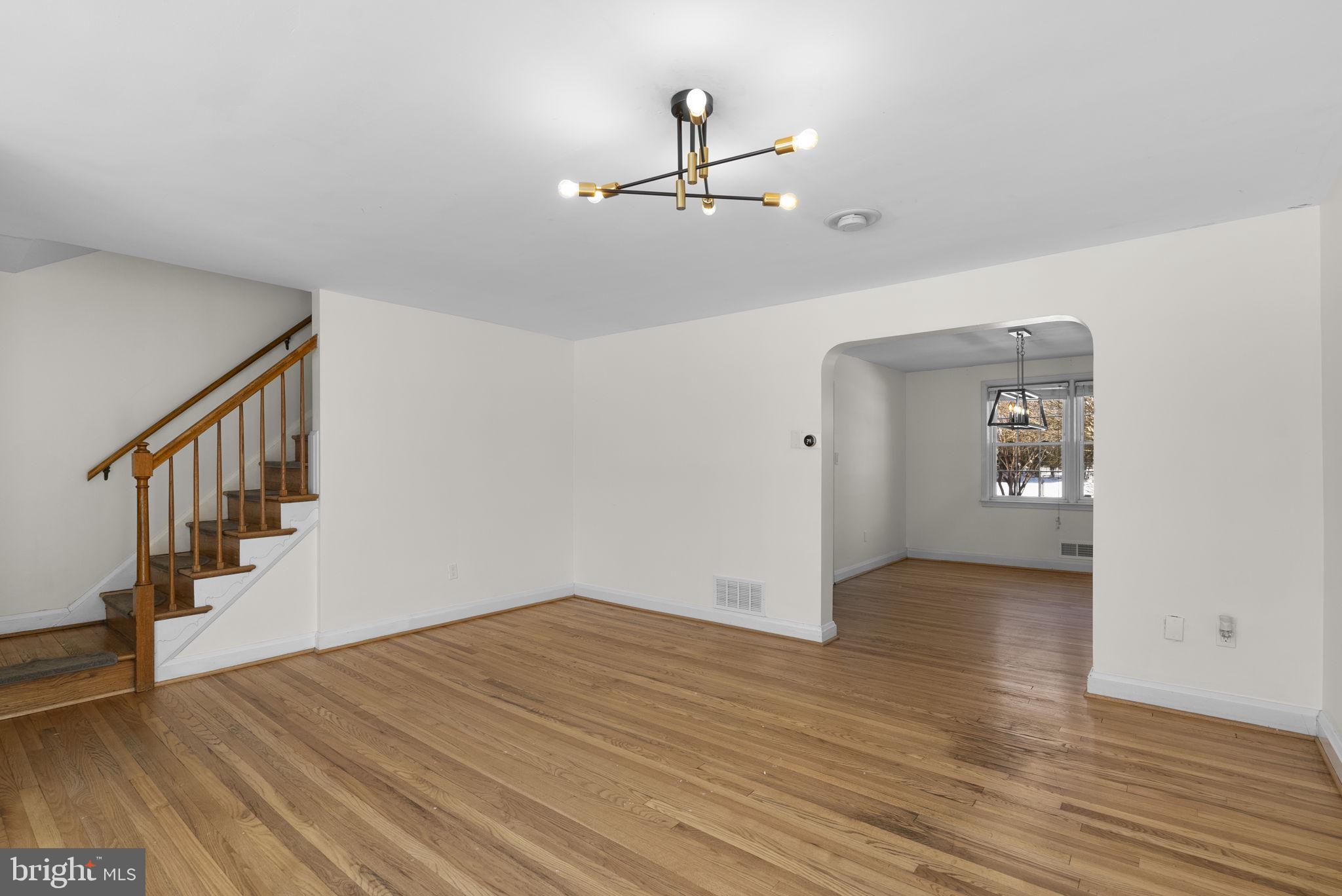 8204 Pleasant Plains Road Towson, MD 21286 - Photo 9 of 40 a view of an empty room with wooden floor and a ceiling fan