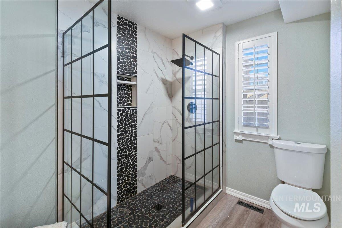 1981 North Interlachen Way Meridian, ID 83646 - Photo 17 of 24 Full bath with a marble finish shower and wood finished floors