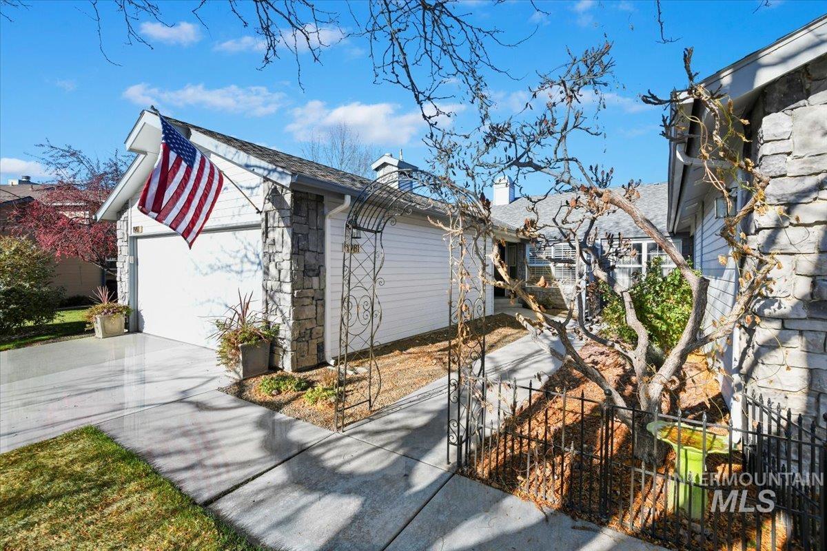 1981 North Interlachen Way Meridian, ID 83646 - Photo 4 of 24 View of home's exterior featuring driveway, a chimney, and an attached garage