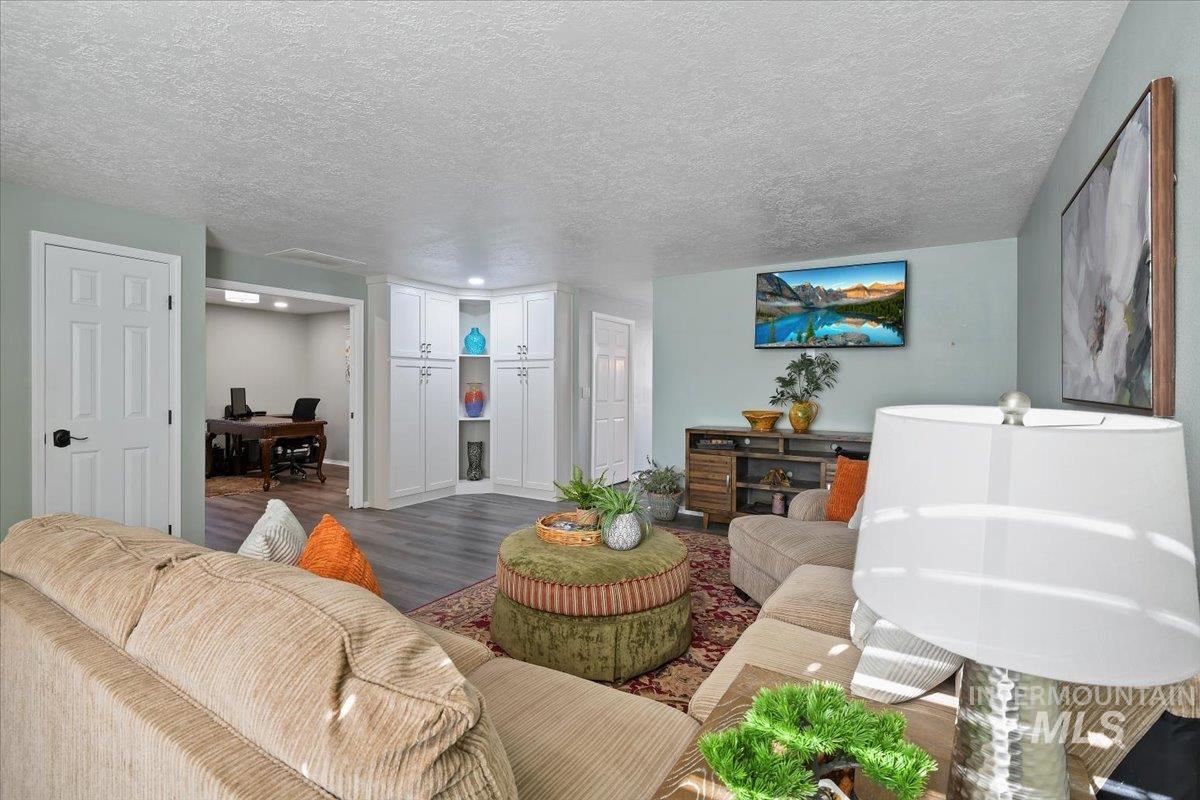 1981 North Interlachen Way Meridian, ID 83646 - Photo 8 of 24 Living area with a desk, a textured ceiling, and wood finished floors