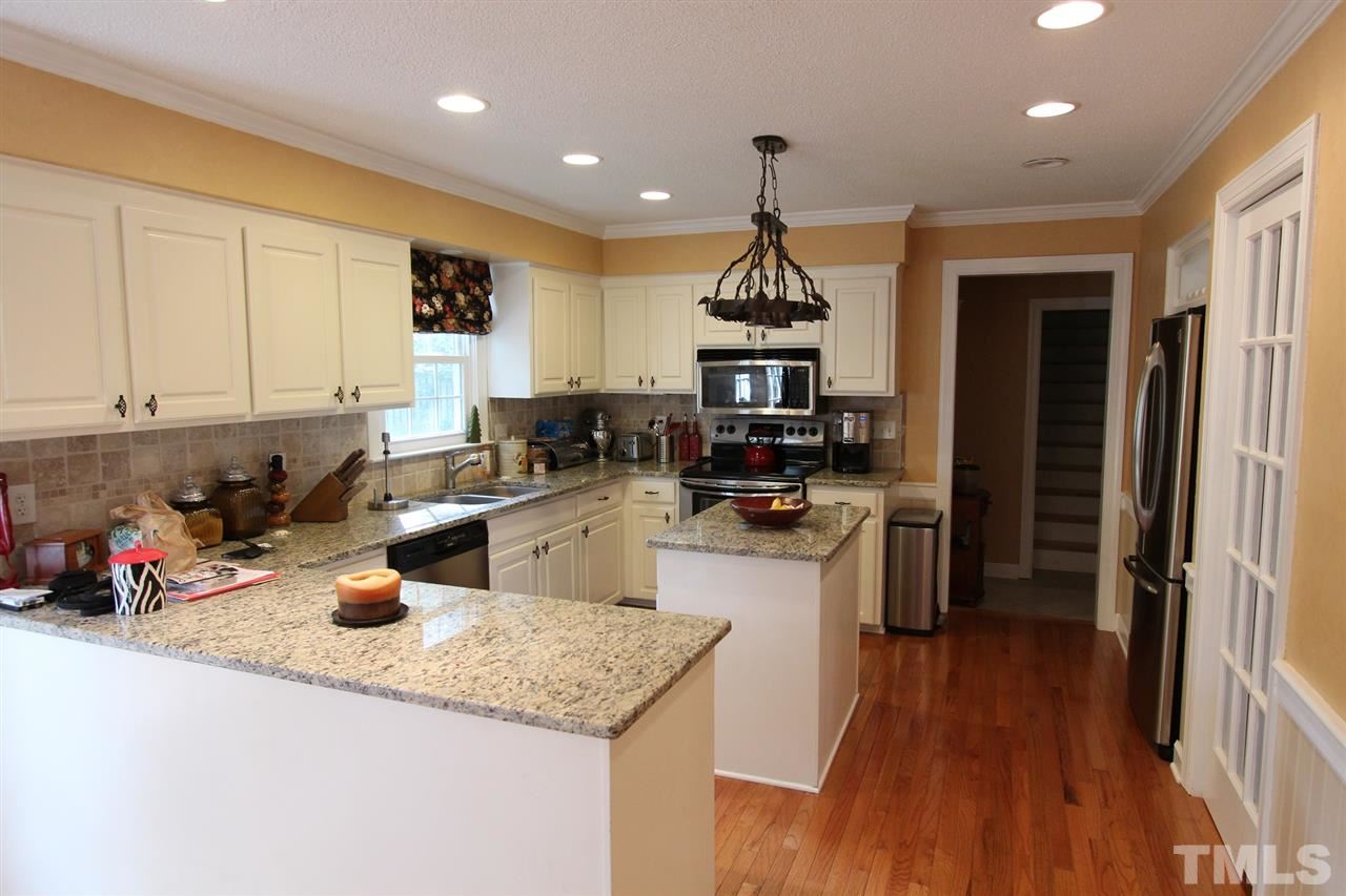 8317 Apple Orchard Way Raleigh, NC 27615 - Photo 2 of 12 a kitchen with sink a refrigerator and cabinets