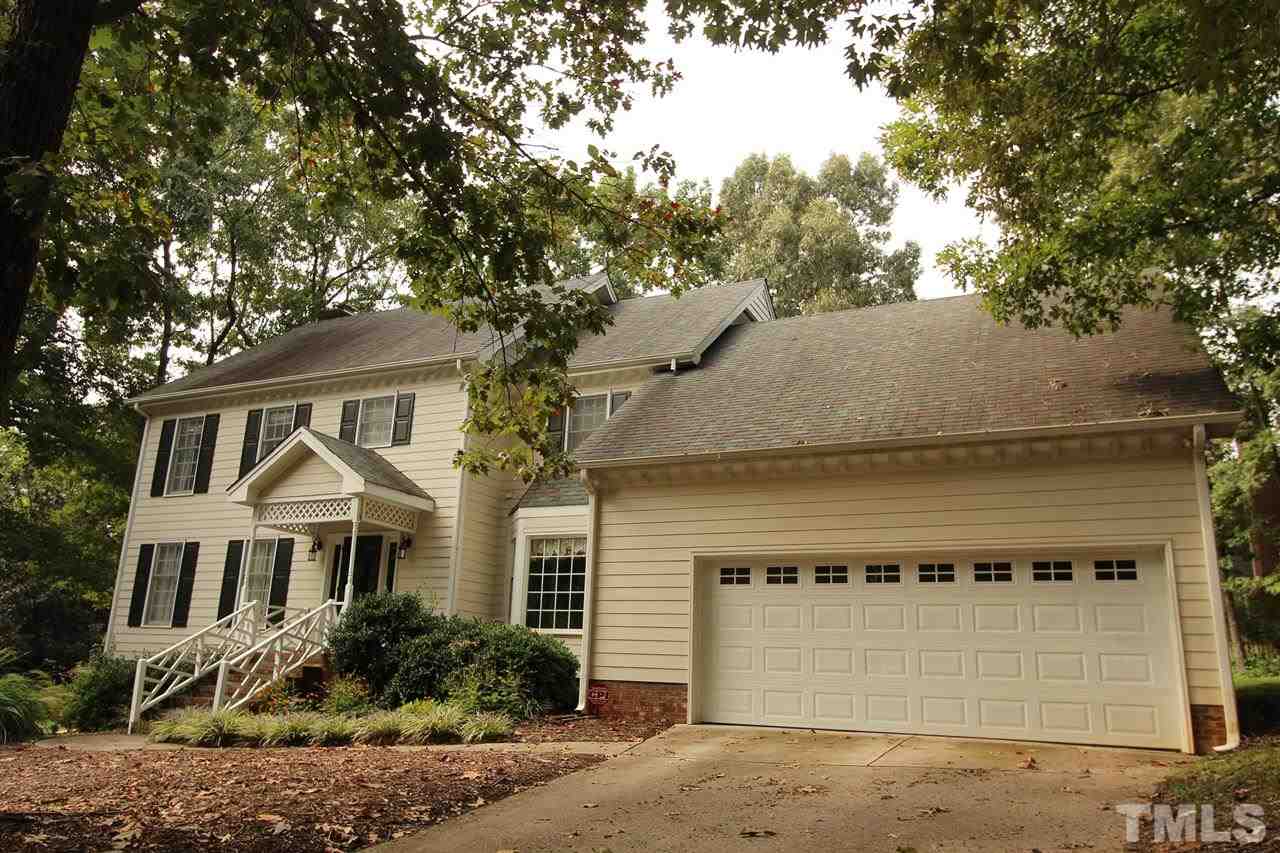 8317 Apple Orchard Way Raleigh, NC 27615 - Photo 12 of 12 a front view of a house with a yard and garage