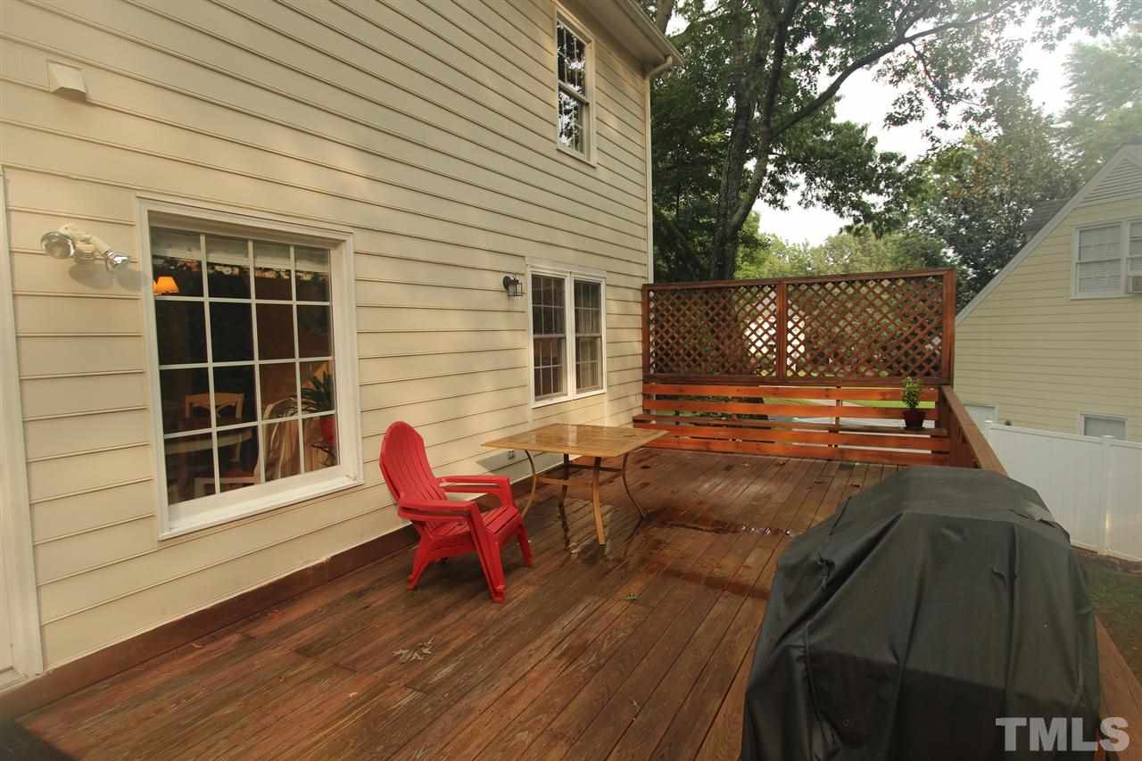 8317 Apple Orchard Way Raleigh, NC 27615 - Photo 10 of 12 a view of a deck with table and chairs and wooden floor
