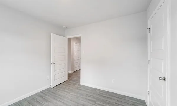 a view of an empty room and wooden floor