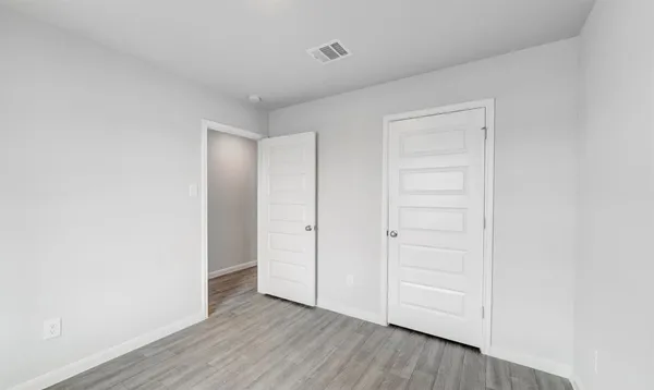 a view of an empty room and wooden floor