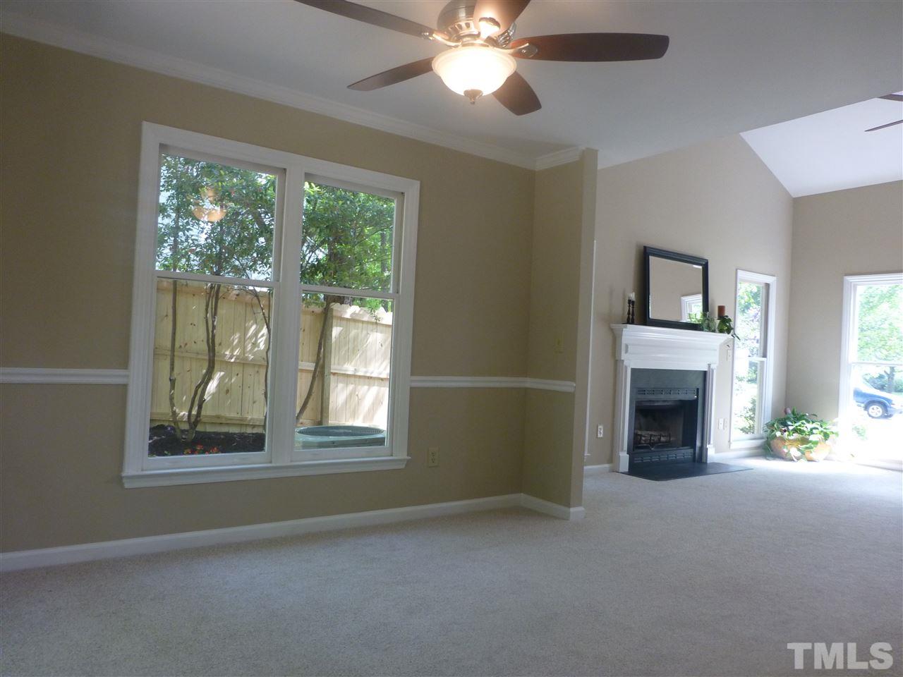 3612 Epperly Court Raleigh, NC 27616 - Photo 11 of 25 a view of livingroom with window fireplace and chandelier fan