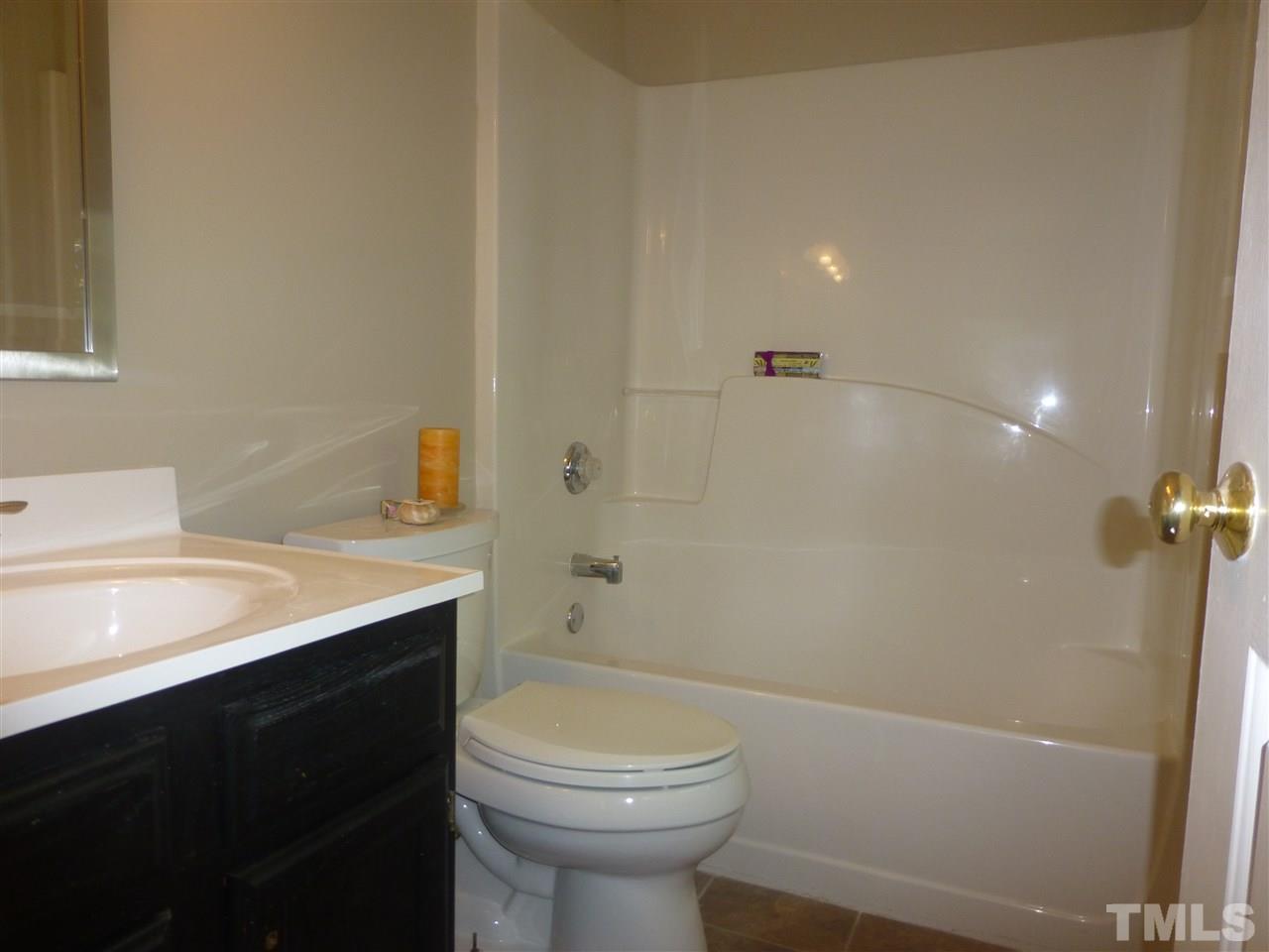 3612 Epperly Court Raleigh, NC 27616 - Photo 16 of 25 a bathroom with a sink a toilet and shower