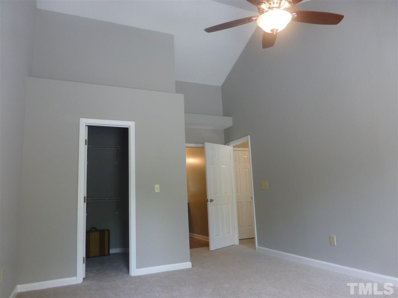 3612 Epperly Court Raleigh, NC 27616 - Photo 18 of 25 an empty room with closet and a chandelier fan