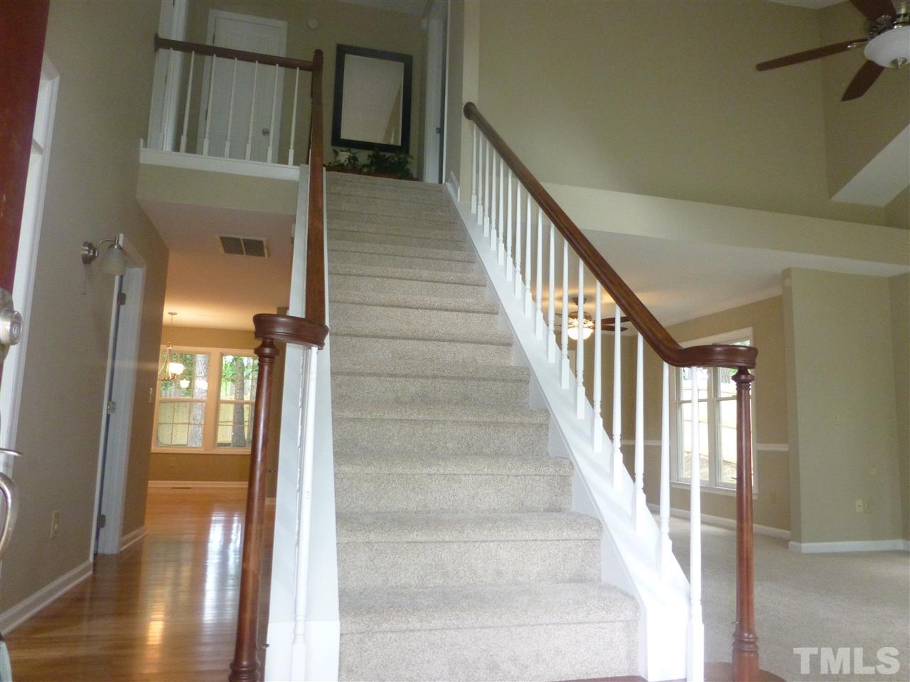3612 Epperly Court Raleigh, NC 27616 - Photo 5 of 25 a view of staircase with lots of frames on wall and windows