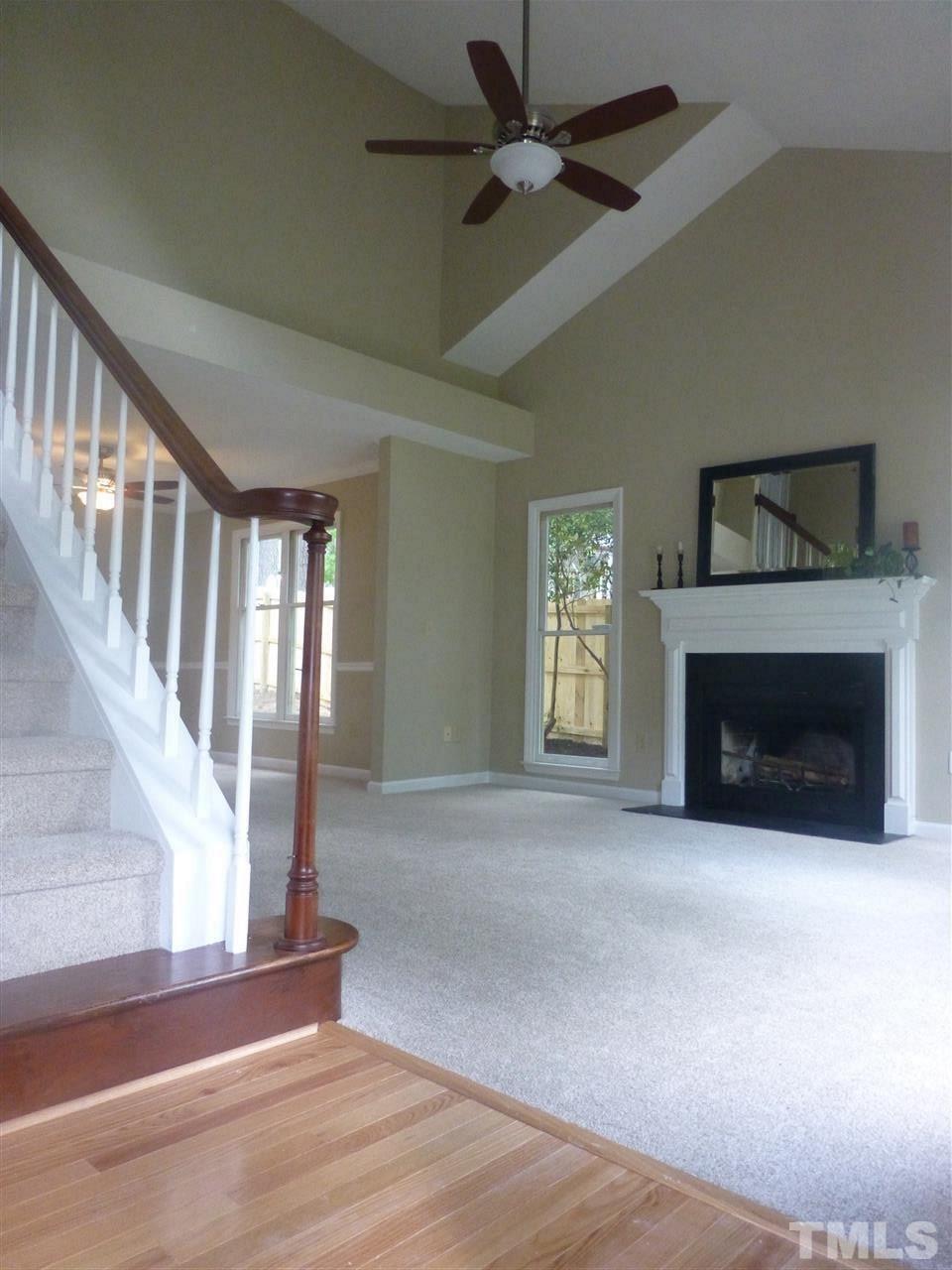 3612 Epperly Court Raleigh, NC 27616 - Photo 6 of 25 a view of empty room with fireplace and fan