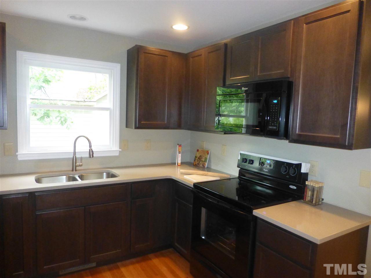 3612 Epperly Court Raleigh, NC 27616 - Photo 7 of 25 a kitchen with a sink cabinets and window