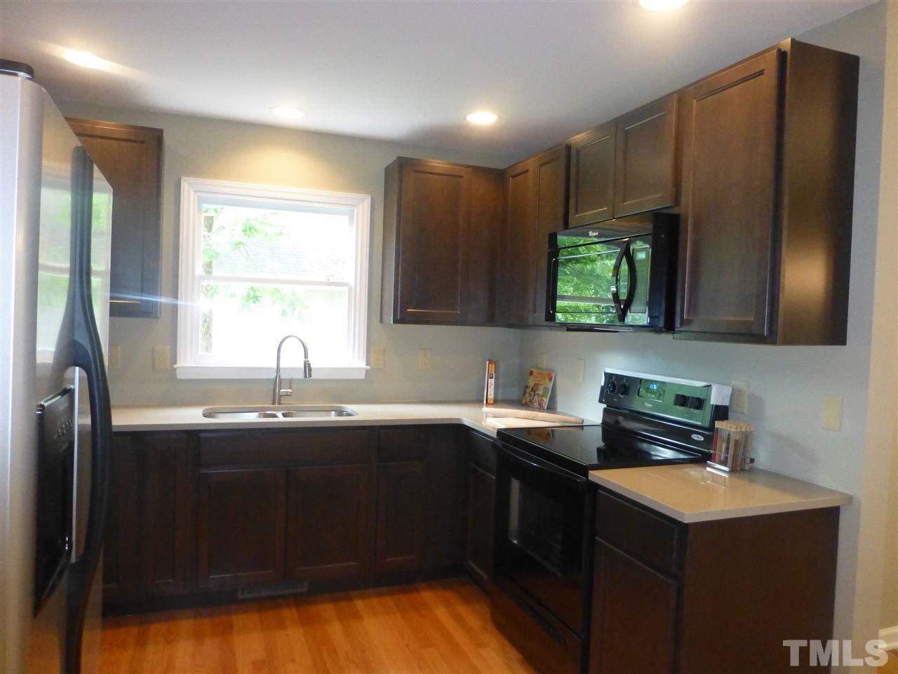 3612 Epperly Court Raleigh, NC 27616 - Photo 8 of 25 a kitchen with stainless steel appliances a sink cabinets and a refrigerator