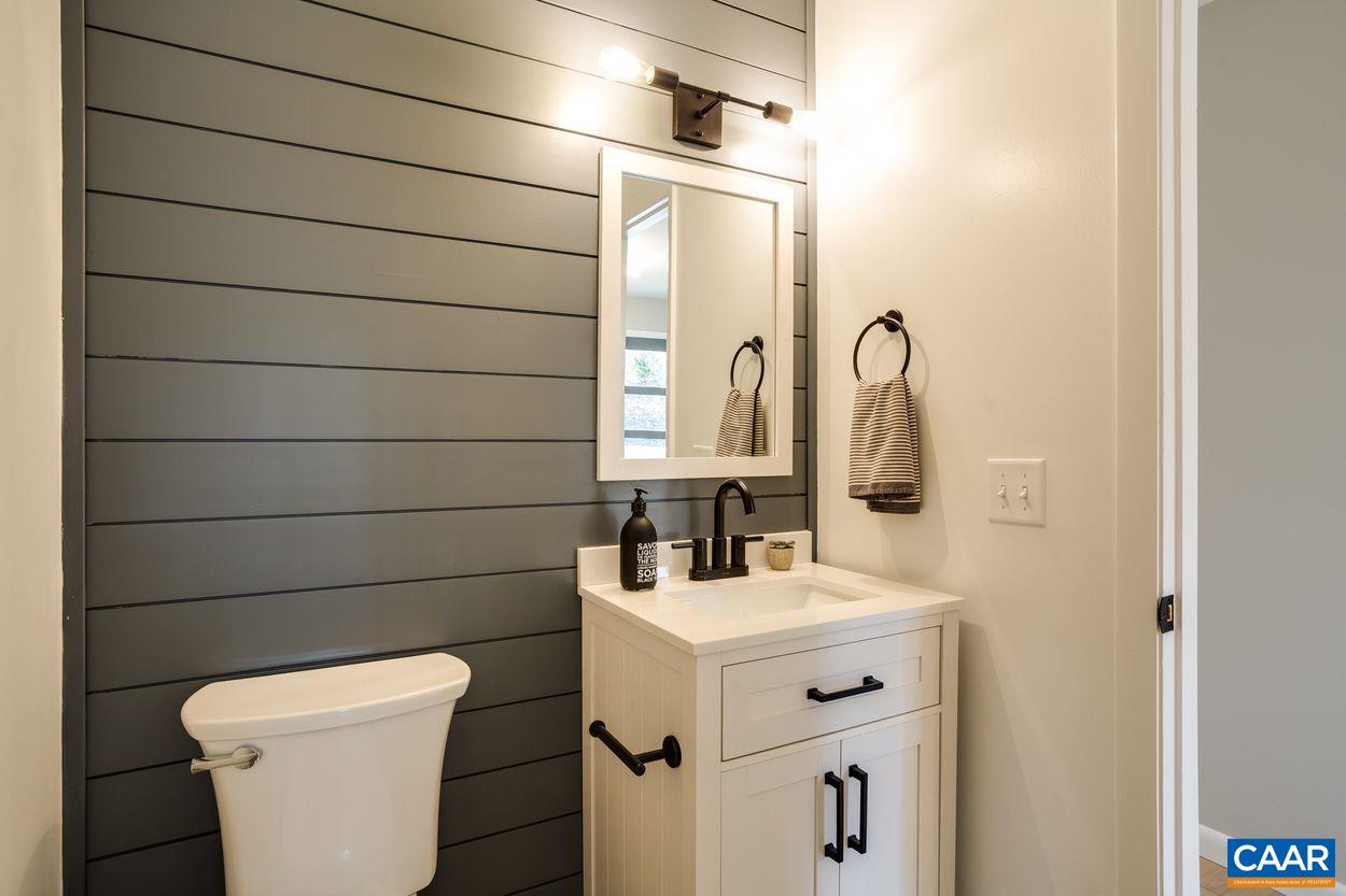 321 Gillums Ridge Road Charlottesville, VA 22903 - Photo 14 of 61 a bathroom with a sink toilet and mirror