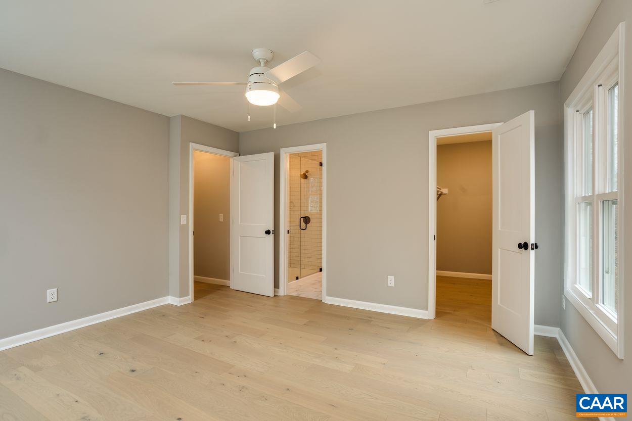 321 Gillums Ridge Road Charlottesville, VA 22903 - Photo 28 of 61 an empty room with fan and entrance